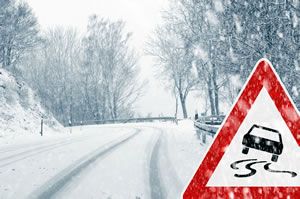 Snowy road with traffic warning sign